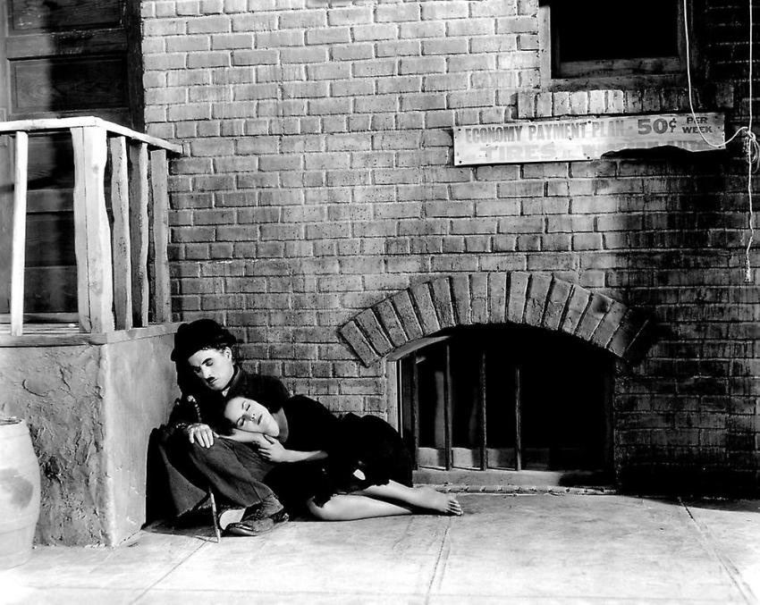 Woman sleeping on Charlie Chaplin's knees